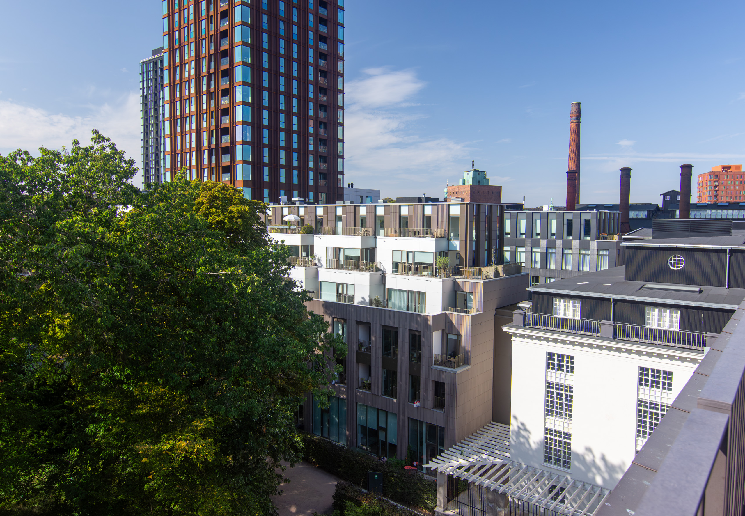 Another shot looking out from the rooftop. The older looking white building to the right is the old mineral water factory built circa 1920 (Mineralvandsfabrikken). Apparently, Carlsberg founder J.C. Jacobsen was the first to bottle/sell soda water in Scandinavia. Interestingly, soda water in Denmark is called Danskvand (Danish water). It’s thought this naming was used to distinguish it from Swedish soda water, which was often coloured red (source). © 2024. This work is openly licensed via CC BY-NC 4.0