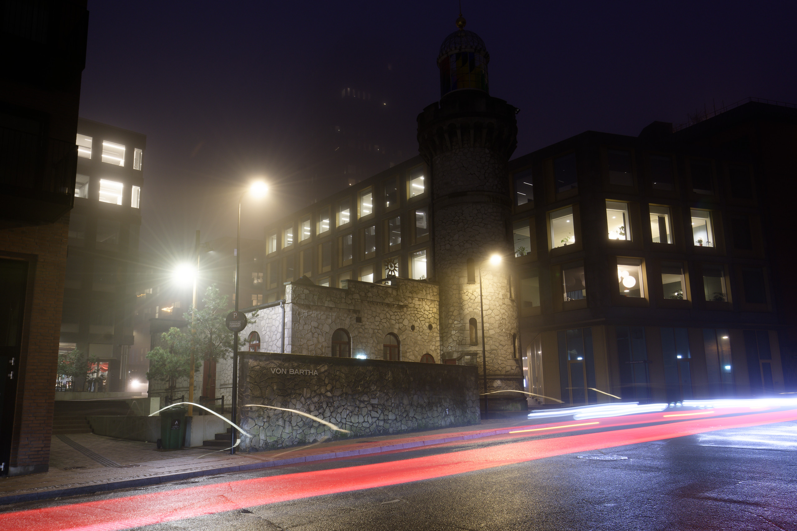 Long exposure for car/bike light trails. The mist obscures a tower in the background. © 2025. This work is openly licensed via CC BY-NC 4.0